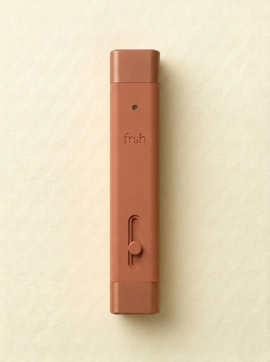frsh Cinnamon — dusty terracotta dual-end mouth spray and lip balm stick on cream paper